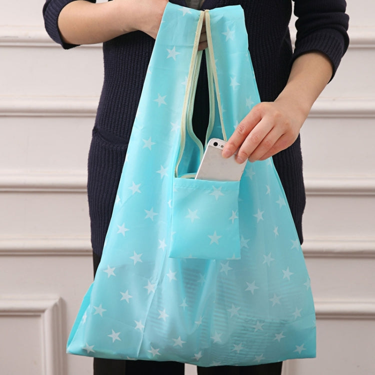 Foldable shopping bag, light teal with white stars, carried tote with wide handles