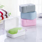Assorted portable soap boxes in gray, pink, white, and green with hinged lids