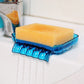 Blue suction cup drainage soap box holding a yellow sponge on bathroom tile