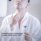 Manual multi-shock razor in hand near face, preparing for shaving