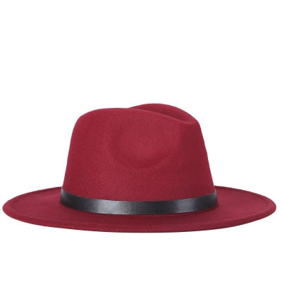 Wine red fedora hat with black band and buckle, wide brim, wool-blend jazz style.