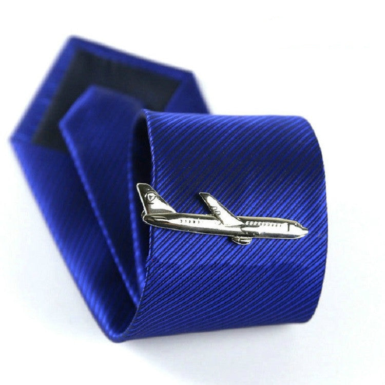 Silver airplane tie clip on blue striped necktie, with matching gift box behind