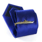 Gold warship tie clip on blue striped necktie, with matching box behind