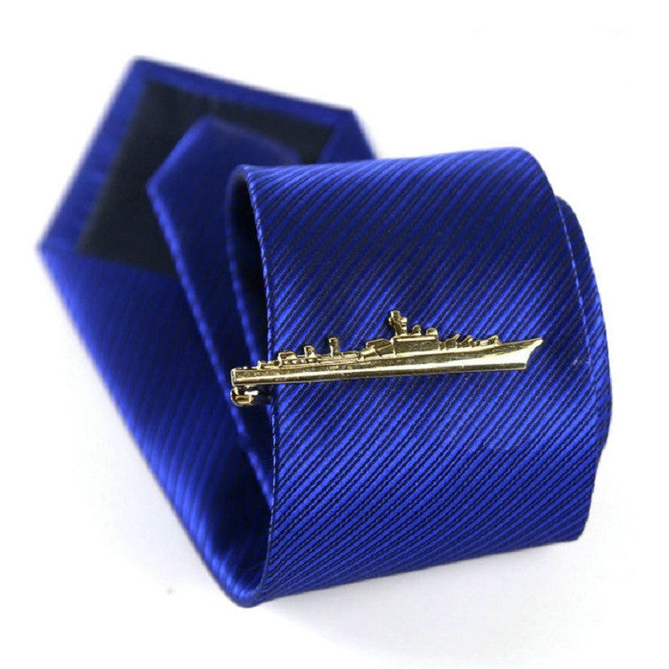 Gold warship tie clip on blue striped necktie, with matching box behind