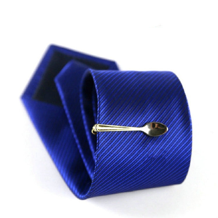 Gold spoon tie clip on blue striped necktie, shown with gift box