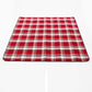 Folded outdoor camping mat with red, white, and black plaid grid pattern