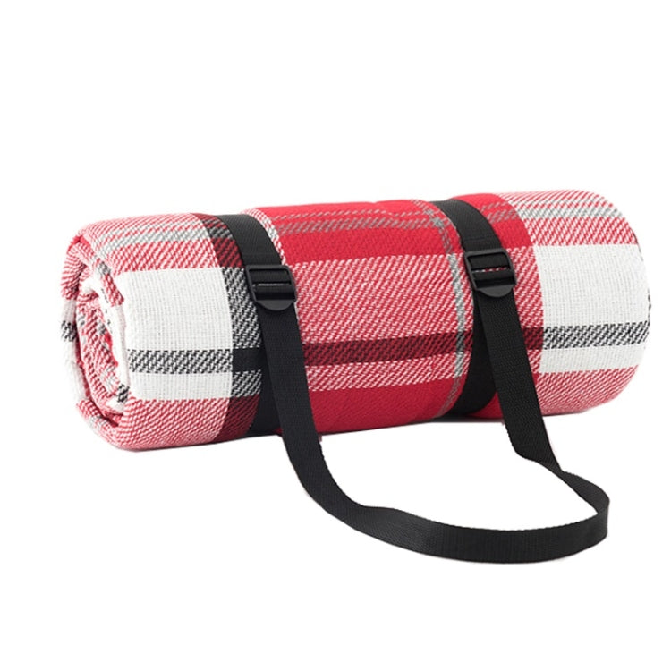 Red and white checkered beach mat roll with black carrying straps