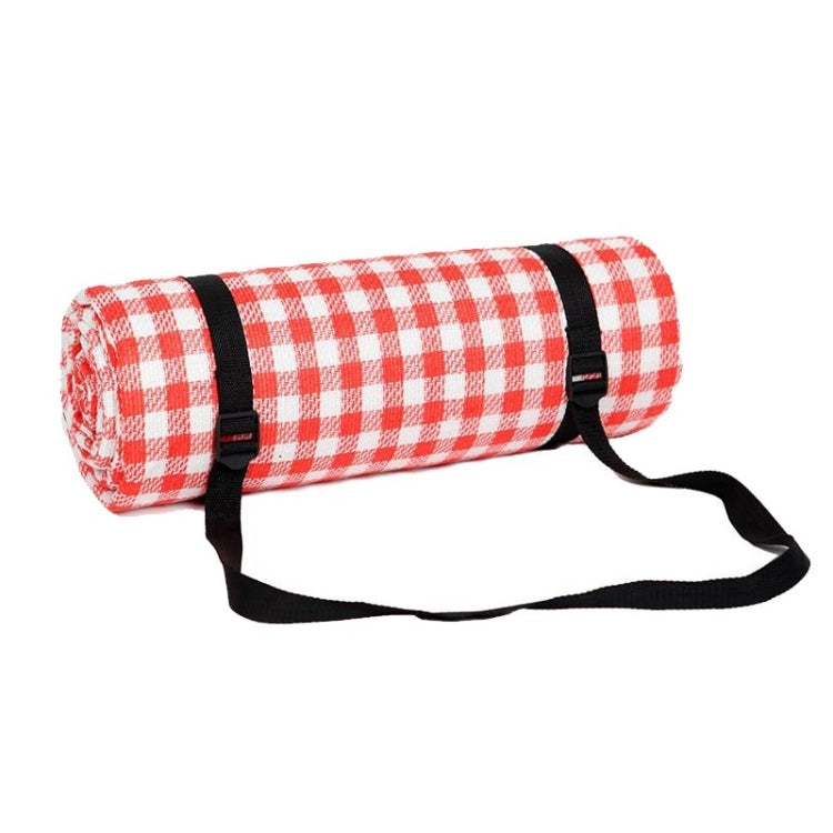 Red and white checkered beach mat roll with black carrying straps