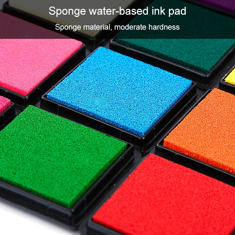 Blue and green square ink pads in black tray, textured sponge surfaces close-up