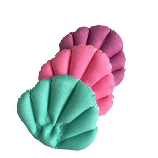 Shell-shaped inflatable bath pillow with pink and teal scalloped design