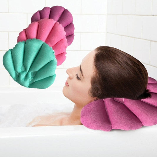 Shell-shaped inflatable bath pillow with pink and teal scalloped design