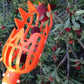 Orange plastic fruit picking cage with long handle and dark berry fruit