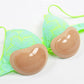 Skin-tone silicone nipple covers paired with bright lace bra cups and straps.