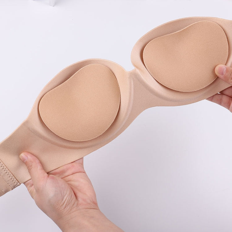 Skin-tone silicone nipple cover pads applied on a nude bra backdrop, two pieces.