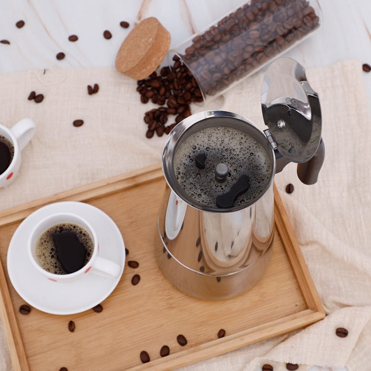 Stainless steel moka coffee maker with black handle, open pot view