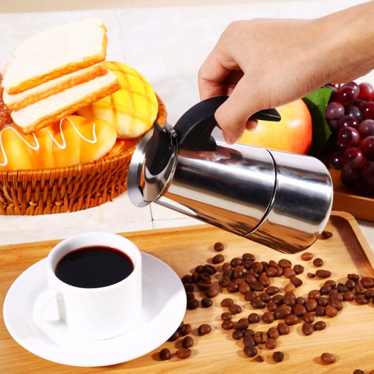 Stainless steel moka coffee maker pot with black handle, pouring spout