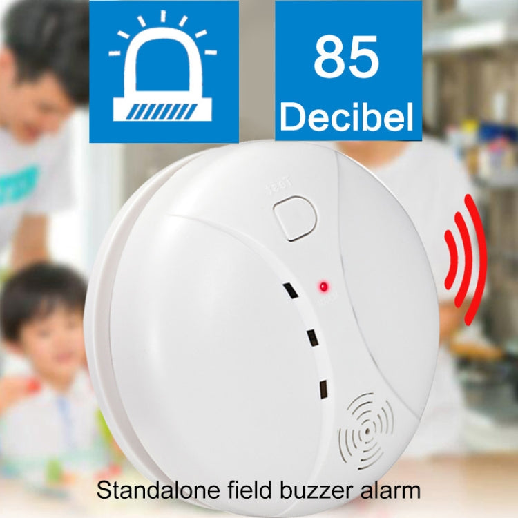 White circular smoke detector with top button, red status LED, and side speaker grille