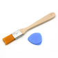 Flat paint brush with wooden handle, silver ferrule, and blue plastic guitar pick