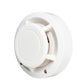 White photoelectric smoke detector showing front cover and internal smoke sensor lens