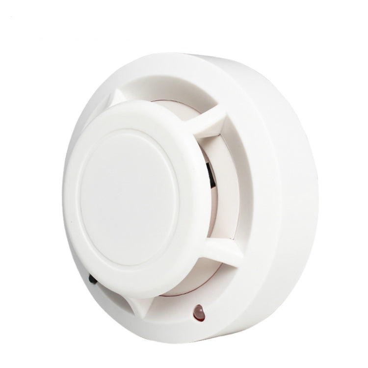 White photoelectric smoke detector showing front cover and internal smoke sensor lens