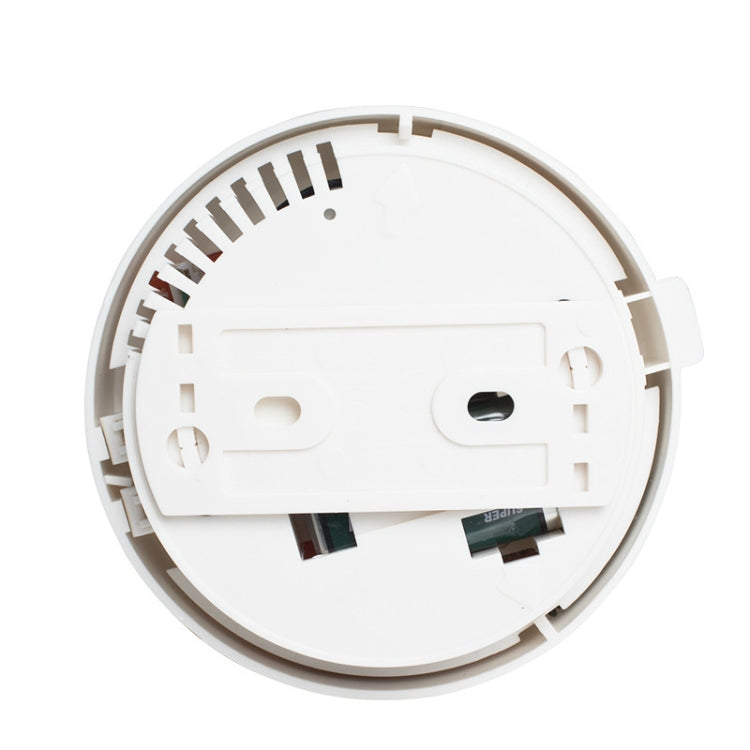 White photoelectric smoke detector base with exposed internal wiring and mounting slots
