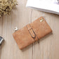 Brown suede-style long wallet phone bag with zip, wrap strap, and gold-tone clasp.