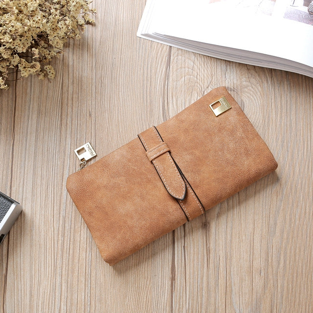 Brown suede-style long wallet phone bag with zip, wrap strap, and gold-tone clasp.