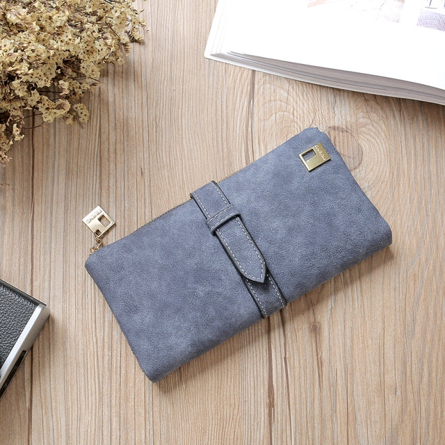 Dark blue suede-style long wallet phone bag with zip, wrap flap strap, and gold-tone clasp.