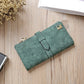 Green suede-style long wallet phone bag with zip, wrap flap strap, and gold-tone clasp.