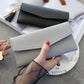 Light gray long zipper clutch wallet with tassel charm and gold-tone chain