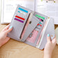 Light gray long zipper clutch wallet open with multiple card slots and bills compartment