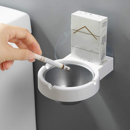 Wall-mounted split ashtray, white with gray metal insert and cigarette in bowl