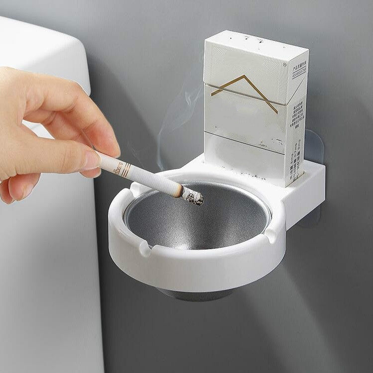 Wall-mounted split ashtray, white bowl with cigarette stub and gray insert