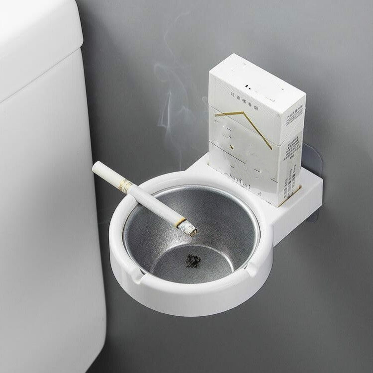 Wall-mounted split ashtray, white with gray insert and cigarette resting in bowl