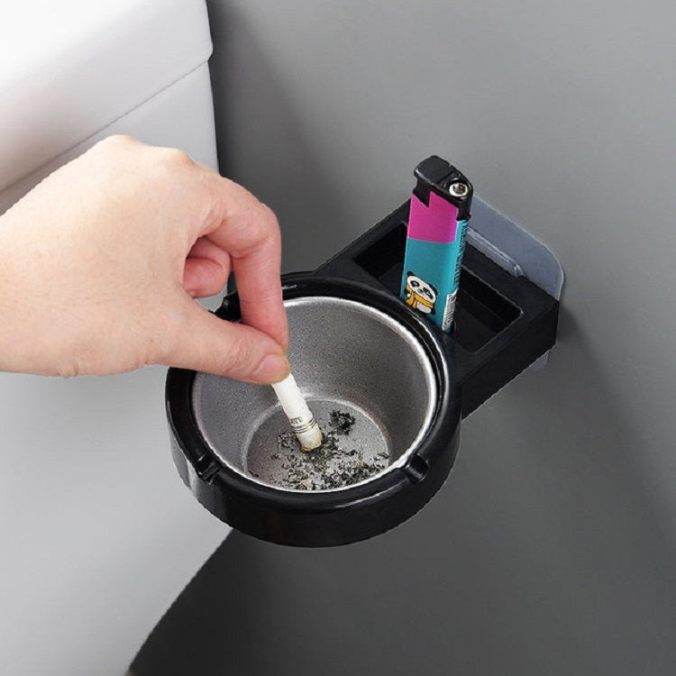 Wall-mounted split ashtray, black with gray insert and cigarette stub in bowl