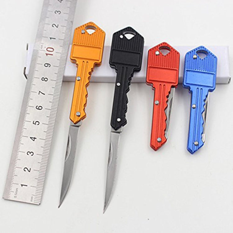 Set of key-shaped mini folding knives in orange, black, red, and blue