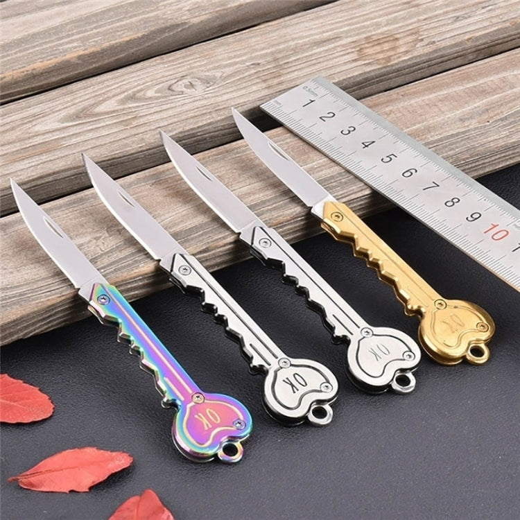 Mini key knife keychain set with several silver and gold open blades