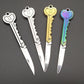 Mini key knife keychain set with silver, gold, and rainbow handles and open blades