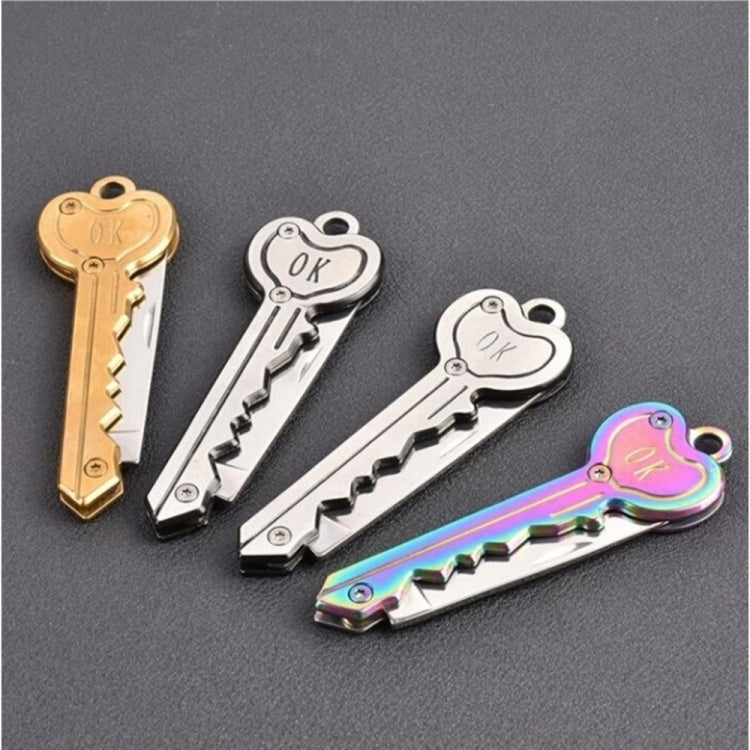 Mini key knife keychain with gold, silver, and rainbow finishes and open blades