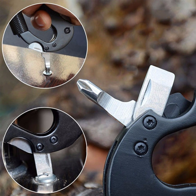 Black D-ring carabiner multitool with bit holder and folding knife close-up.