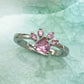 Pink crystal cat-claw ring with open silver-tone band, prong-set stones