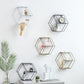Set of hexagonal hanging wall shelves with small decor pieces on open tiers