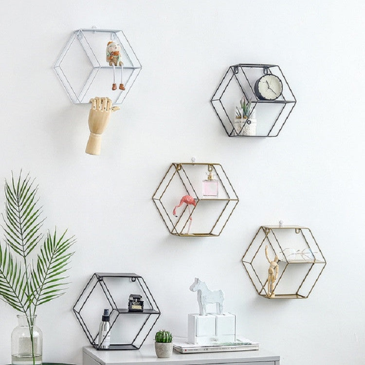Set of hexagonal hanging wall shelves with small decor pieces on open tiers