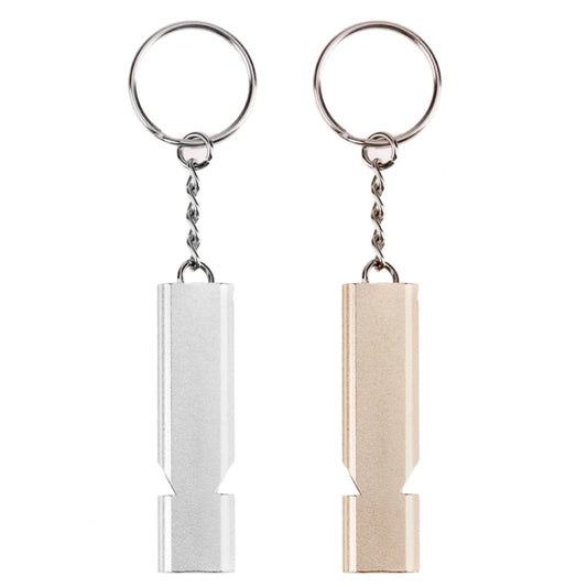Pair of double-pipe whistle keychains in silver and gold, each with metal chain ring