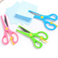 Set of pink, blue, green, and yellow safety scissors with elastic action and curved guards