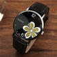 Ladies quartz watch with black leather strap, silver case, black dial with gold glitter four-leaf clover