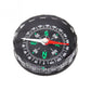 Black round mini compass with green direction letters and red needle, clear dial rim