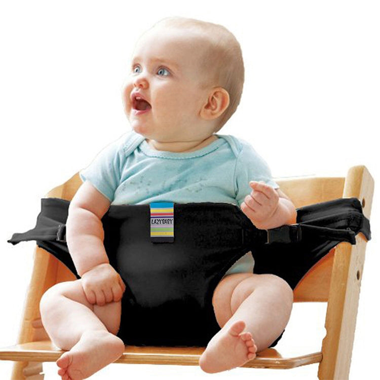 Black baby chair seat safety harness with shoulder straps and buckle on a dining booster