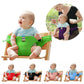 Green baby chair seat safety harness on a dining booster with straps and buckle