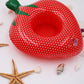 Red polka-dot inflatable strawberry cup coaster with green leaf handle and raised rim